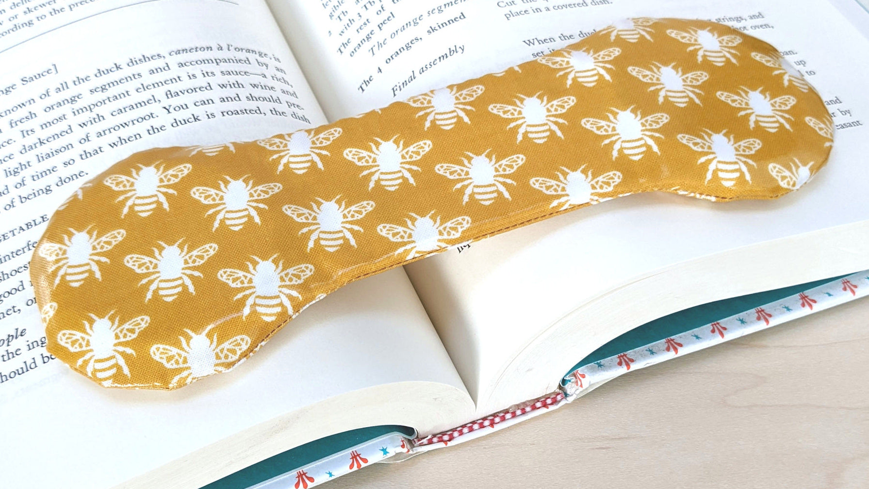 yellow book weight with honeybee pattern
