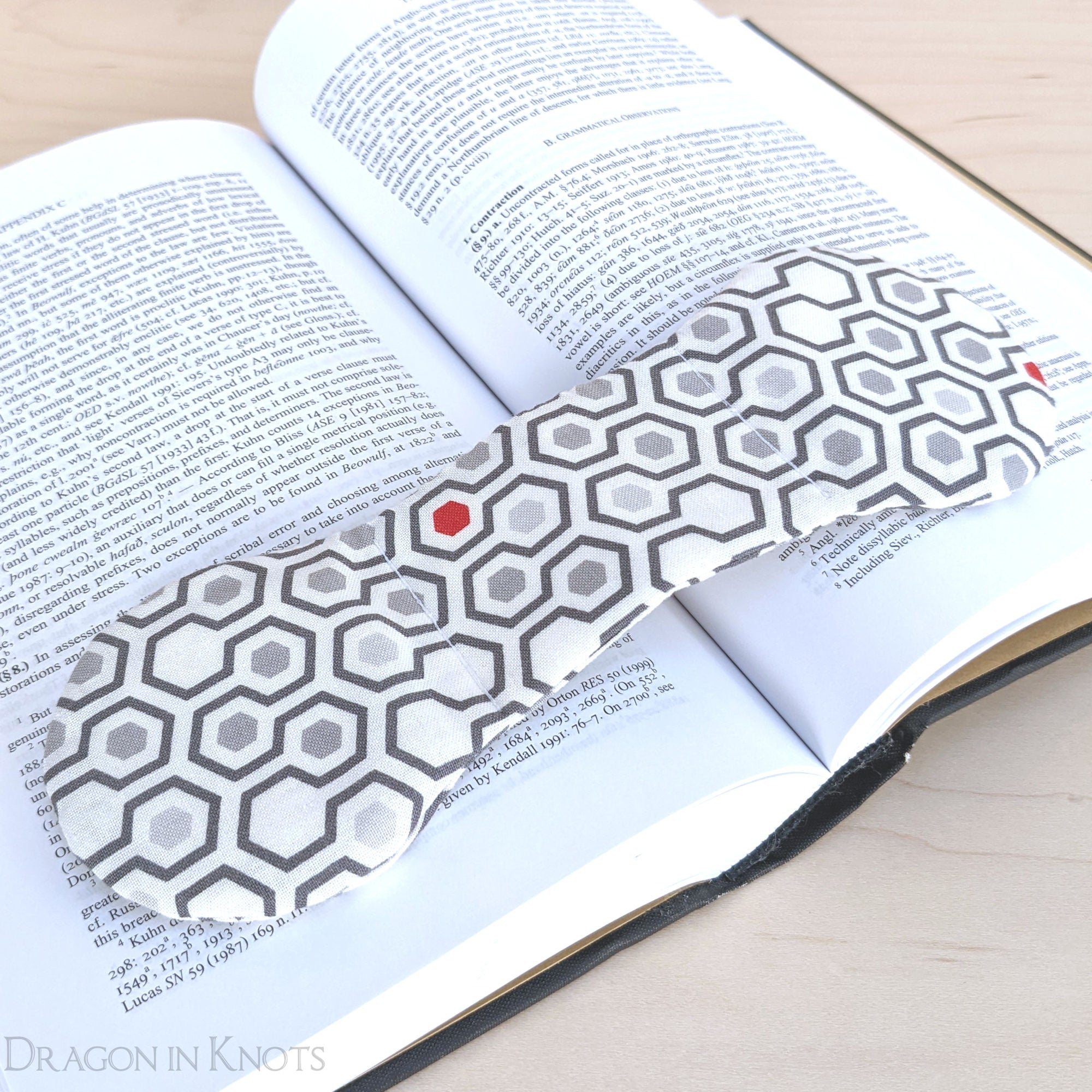 Hexagonally Weighted Book Page Holder